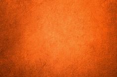 an orange background with some stains on it