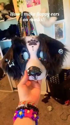 a person holding up a dog mask with the words how i make floppy ears on musks