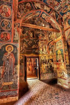 the interior of an old church with paintings on it