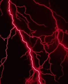 red lightning strikes in the dark sky with bright lights on its face and back ground