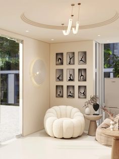 a living room filled with furniture and pictures on the wall