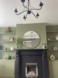 a living room with a fire place and a mirror on the wall above it's mantle