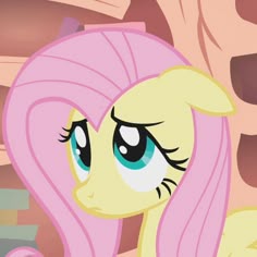 a pink pony with long hair and blue eyes looking at something in front of her