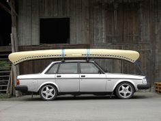 an old station wagon with a surfboard on top