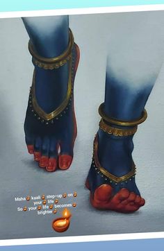 the feet and ankles of a woman wearing blue sandals with gold chains around their ankles