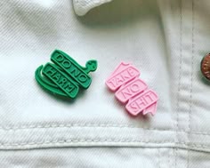 two badges that say don't be afraid and no one else is on the back of a white jacket