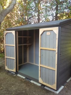 an outdoor storage shed with the door open and shelves in place on the outside side
