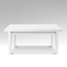 a white table sitting on top of a white floor next to a gray wall in an empty room