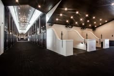 an empty hallway with several urinals and lights