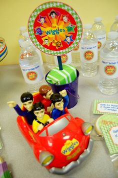 a table topped with toys and water bottles