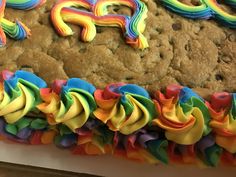 a cookie cake with rainbow icing on it