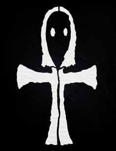 a black and white drawing of an alien cross on a black background with the word,