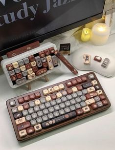a keyboard and mouse sitting on a desk next to a television screen with the words study jazz written on it