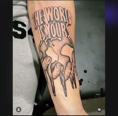 a man with a tattoo on his arm that says the world is yours and dripping paint