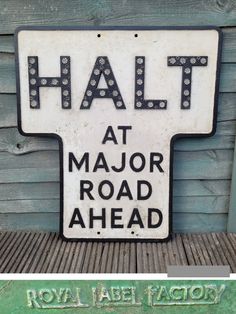 an old sign that says halt at major road ahead and royal label factory on it