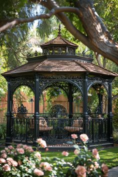 a gazebo in the middle of some flowers and trees