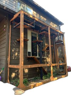 a house with a large chicken cage on the front porch and stairs to the second floor
