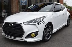 a white car parked in front of a building