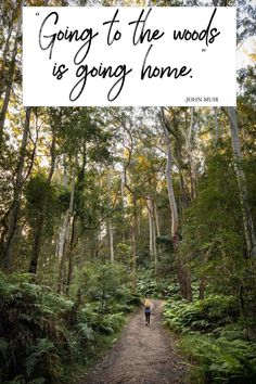 a person walking down a path in the woods with text going to the woods is going home