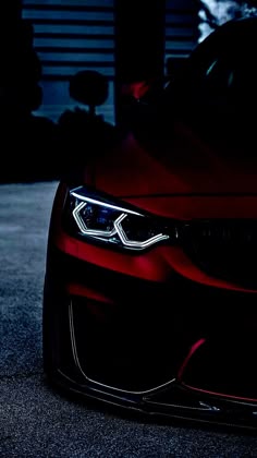 the front end of a red sports car