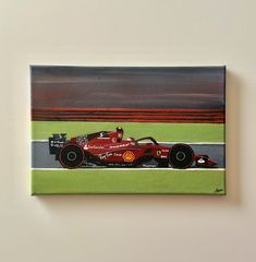 a painting of a red race car driving down the track