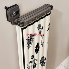 a black and white curtain hanging on the side of a wall