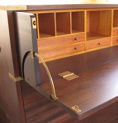 a wooden desk with drawers and metal handles