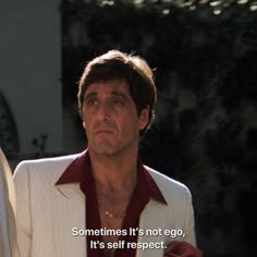 a man in a white suit and red shirt with a quote on his left side