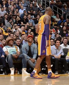 two basketball players standing next to each other on a court