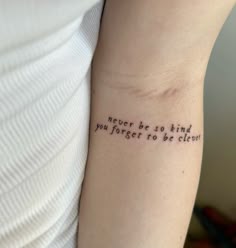 a woman with a tattoo on her arm saying never be so kind you forget to be clown