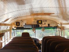 the inside of a bus with lots of seats on it's sides and windows