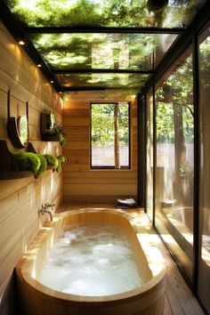 an indoor jacuzzi tub in the middle of a room with wood walls and ceiling