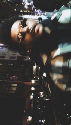 a man with his eyes closed and head tilted to the side in front of him