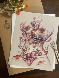 two cards with flowers on them sitting next to each other, one has a drawing of a woman's face