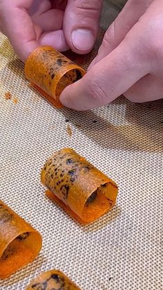 a person is making something out of rolled up food
