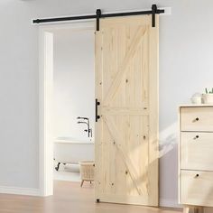 an open sliding door in a white room with wood flooring and drawers on either side