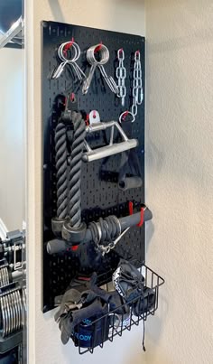 Black Wall Control Pegboard holding gym equipment accessories.