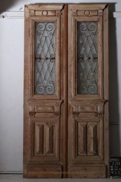 an old wooden door with glass panels on the front and side doors are shown in this photo
