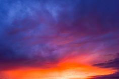an orange and blue sunset over the ocean
