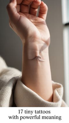 a woman's wrist tattoo with the words, 17 tiny tattoos with powerful meaning