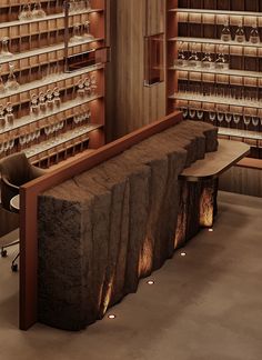 the wine glasses are lined up on the wall behind the bench in the bar area