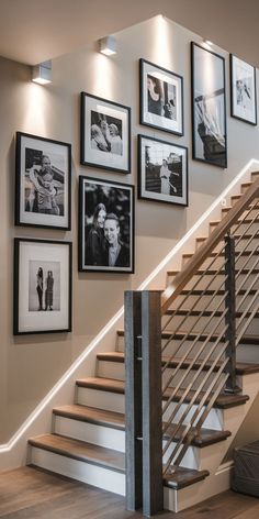 a staircase with pictures on the wall next to it and framed photos hanging on the wall