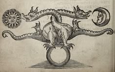 an old book with a drawing of a dragon on it's back and sun above the head