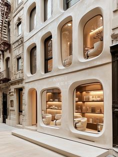 a store front with many windows on the side of it and shelves filled with items