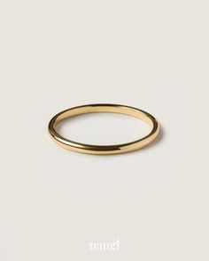a gold wedding ring on a white background with the word nange written below it