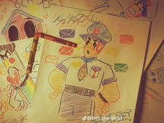 two children's drawings and a crayon pencil on top of some paper