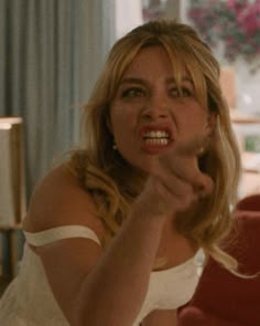 a woman pointing her finger at the camera