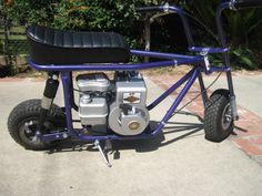 the small motorcycle is parked on the sidewalk