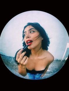 a woman holding a black object in her right hand