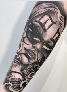 a man's arm with a black and white tattoo on it